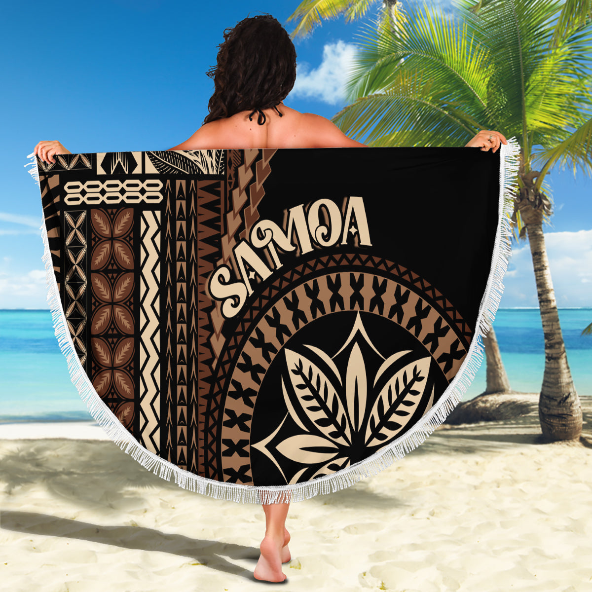 Black round beach blanket with white fringe, SAMOA lettering and large leaf emblem