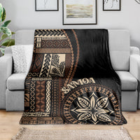 Black Samoa siapo motif blanket draped over couch with geometric border and leaf medallion