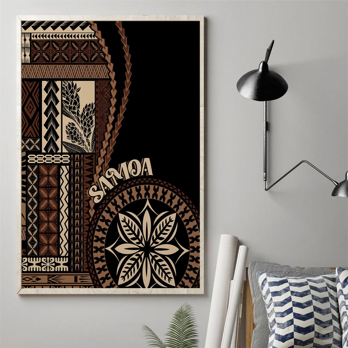 Framed black canvas wall art featuring diagonal tapa patterns and large leaf emblem