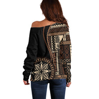 Off-shoulder black sweater with large back siapo-style geometric motif