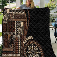 Black Samoa siapo motif quilt with tan geometric panels and leaf emblem print