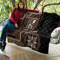 Black Samoa siapo motif quilt blanket featuring tan geometric panels and leaf emblem