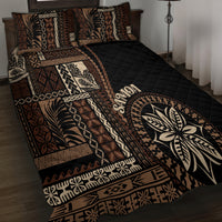 Black quilt bed set with tan and cream geometric siapo patterns and leaf emblem center