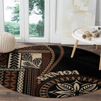 Black round siapo motif rug with 'Samoa' text and geometric panel detail along edge