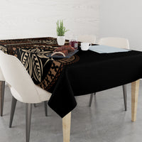 Black siapo motif tablecloth with bold leaf and geometric designs, on a dining table