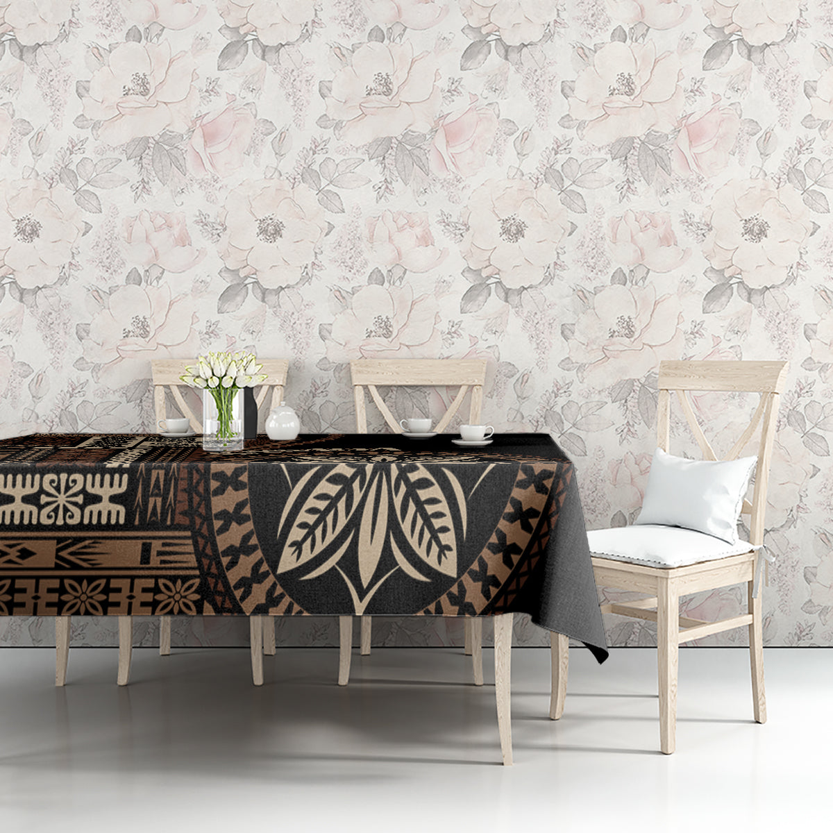 Black siapo motif tablecloth with geometric bands and large leaf prints along the edge