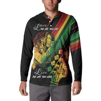 Black button-up sweatshirt on model, reggae portrait print with white script text on front