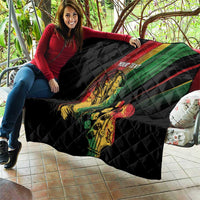 Personalized reggae quilt, black quilt draped over couch with musician print and 'YOUR TEXT'.