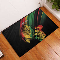 Personalised rubber doormat with reggae faces and 'YOUR TEXT' print, black and green