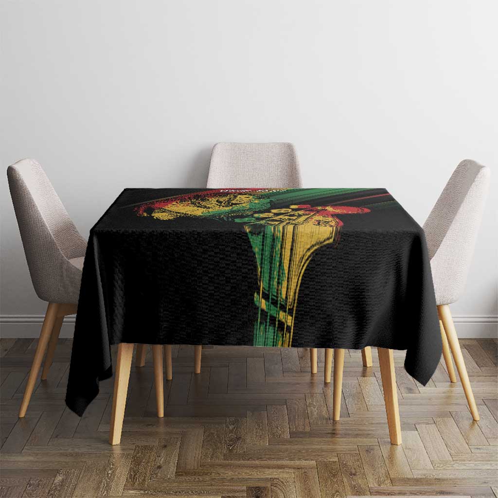 Black reggae tablecloth on dining table with colorful vertical artwork panel and green/red stripe accents