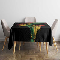 Black reggae tablecloth on dining table with colorful vertical artwork panel and green/red stripe accents