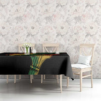 Reggae-themed tablecloth with black fabric, colorful green panel graphic, and red-green stripe trim