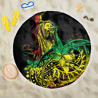 Round beach blanket with white fringe, black reggae-style artwork in green and yellow