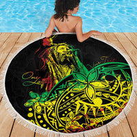 Round beach blanket with white fringe, black design featuring face artwork and green accents