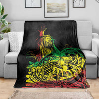 Black blanket featuring reggae dancer artwork and green-yellow tribal emblem on couch