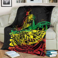 Black blanket with reggae dancer portrait and ornate green-yellow tribal pattern on couch