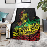Black blanket with reggae dancer and tribal emblem, shown over couch seat