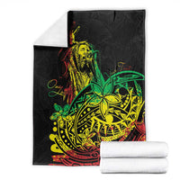 Black blanket with reggae dancer graphic, folded and paired with white towels