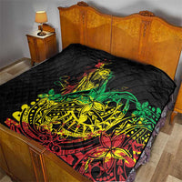 Black quilt on a bed with diamond quilting and colorful reggae dancer print in green and yellow.