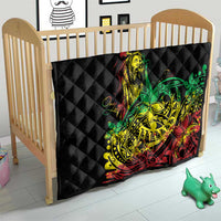 Black diamond-quilted baby blanket with reggae dancer graphic in green, yellow, and red.