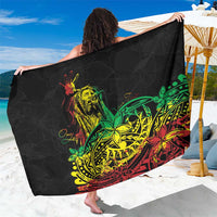Black sarong with green, yellow, and red Polynesian graphic print, held open