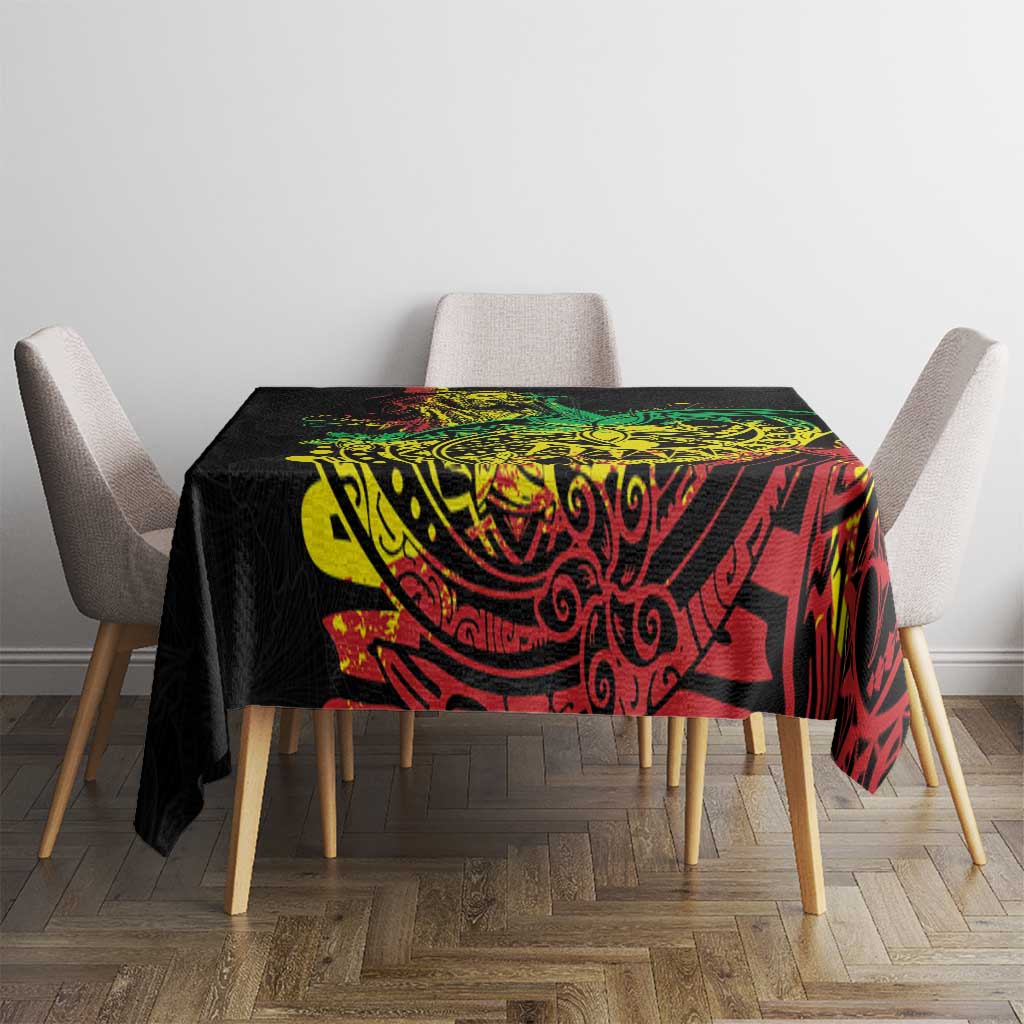 Black reggae tablecloth with red and green ornate patterns over a dining table