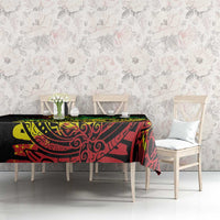 Reggae printed black tablecloth with red and green Polynesian-style motif on dining table