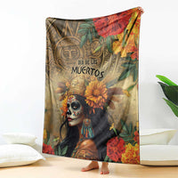 Dia de los Muertos blanket on floor featuring skull-faced goddess and orange-red flowers