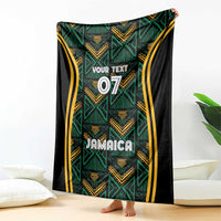 Jamaica reggae blanket with teal geometric motifs, gold stripes, black border