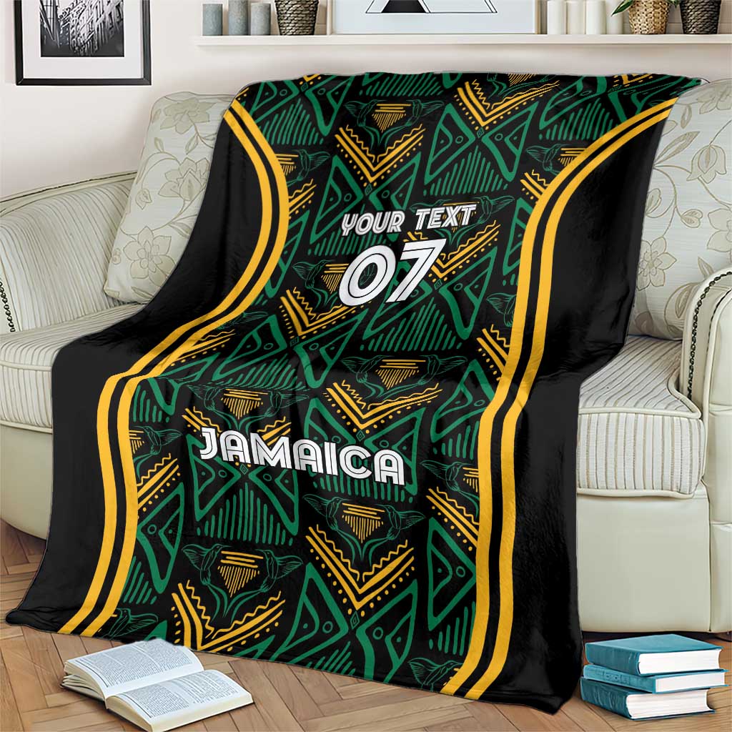 Jamaica reggae blanket on armchair, teal geometric motifs with gold trim and black