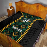 Black quilt on bed with green-and-gold ethnic graphic strip, “Your Text” 07, Jamaica