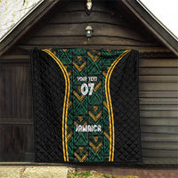 Black quilt hanging outdoors with green geometric panel, gold-trimmed sides, “Your Text” 07, Jamaica