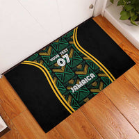 Black rubber doormat with teal and gold ethnic Jamaica design, custom text and 07