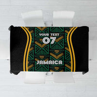 Black tablecloth with green and gold ethnic pattern panels and central Jamaica motif