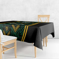 Black tablecloth corner drape with green geometric motif and gold edging