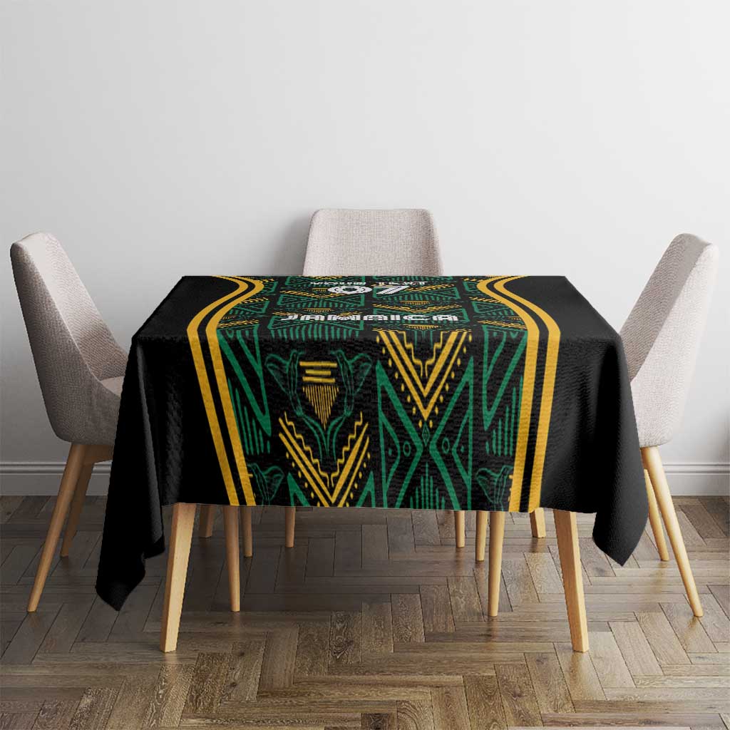 Black tablecloth with green patterned center and thick gold striped frame