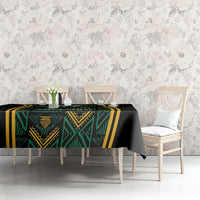 Black tablecloth with green geometric motif and gold border stripes