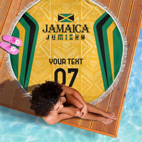Yellow round beach blanket with green-and-black side stripes, gold center design, white fringe