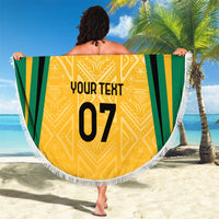Yellow round beach blanket with Jamaica-style stripes, gold emblem, your text 07, and fringe