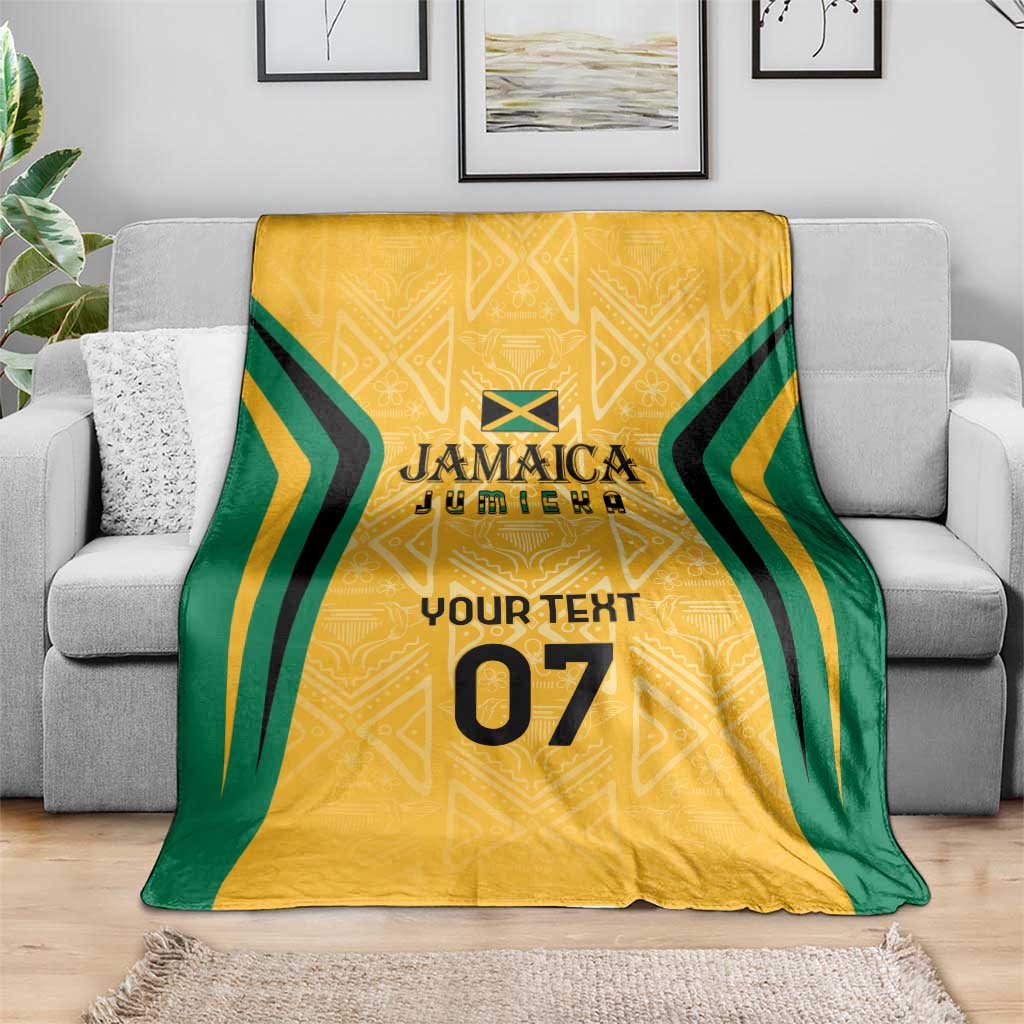 Yellow ethnic blanket with green stripes and number 07, spread on gray sofa