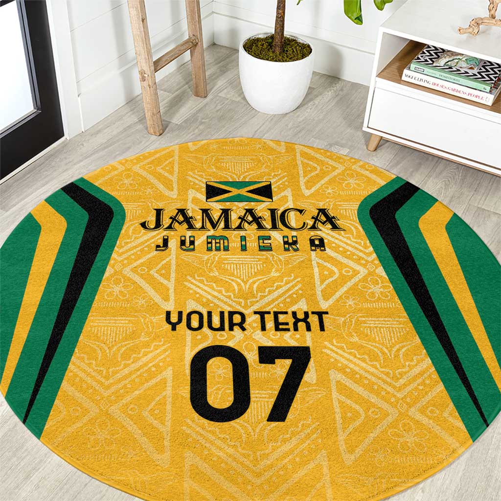 Round yellow ethnic area rug with green-and-black chevrons and gold-accent motifs