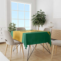 Yellow-and-green Jamaica tablecloth draped over dining table with ethnic pattern