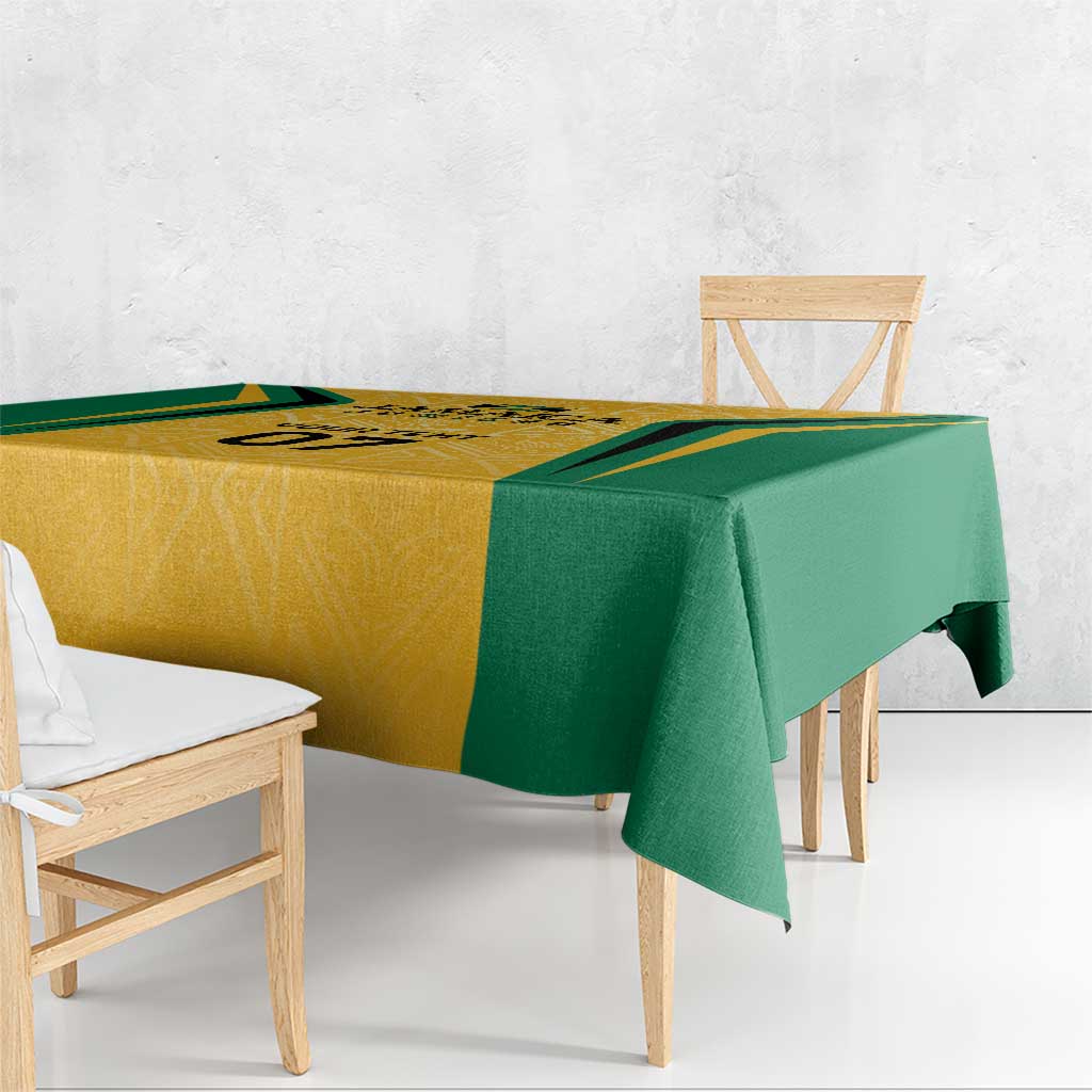 Jamaica tablecloth with yellow geometric panel and green border, draped over bench