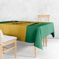 Jamaica tablecloth with yellow geometric panel and green border, draped over bench