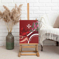 Red canvas print on an easel with Malta skyline, Maltese cross, and pink bougainvillea