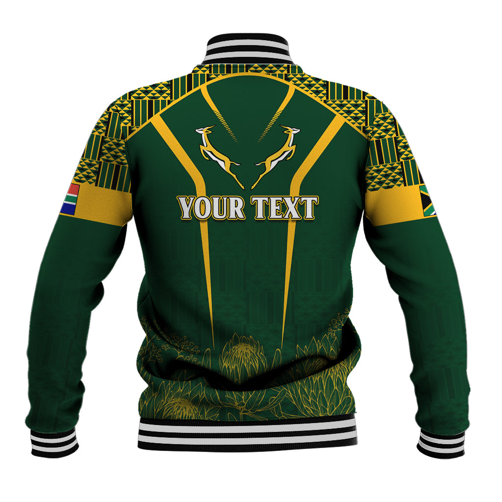 Green baseball jacket with kente-style pattern, gold trim, 'Your Text' back print, antelope emblem