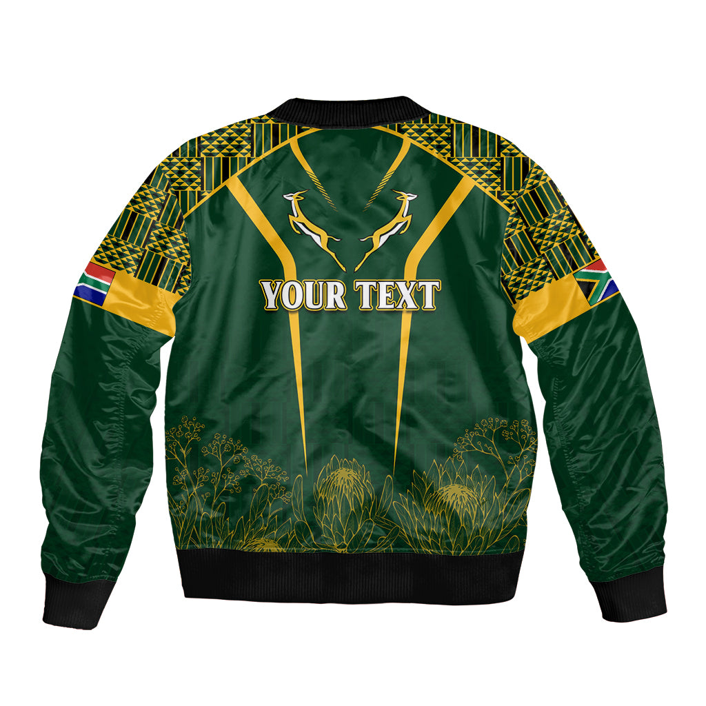 Green bomber jacket with kente patterned sleeves and panel, YOUR TEXT front print