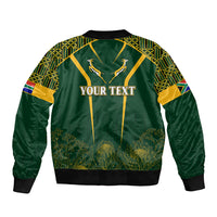 Green bomber jacket with kente patterned sleeves and panel, YOUR TEXT front print