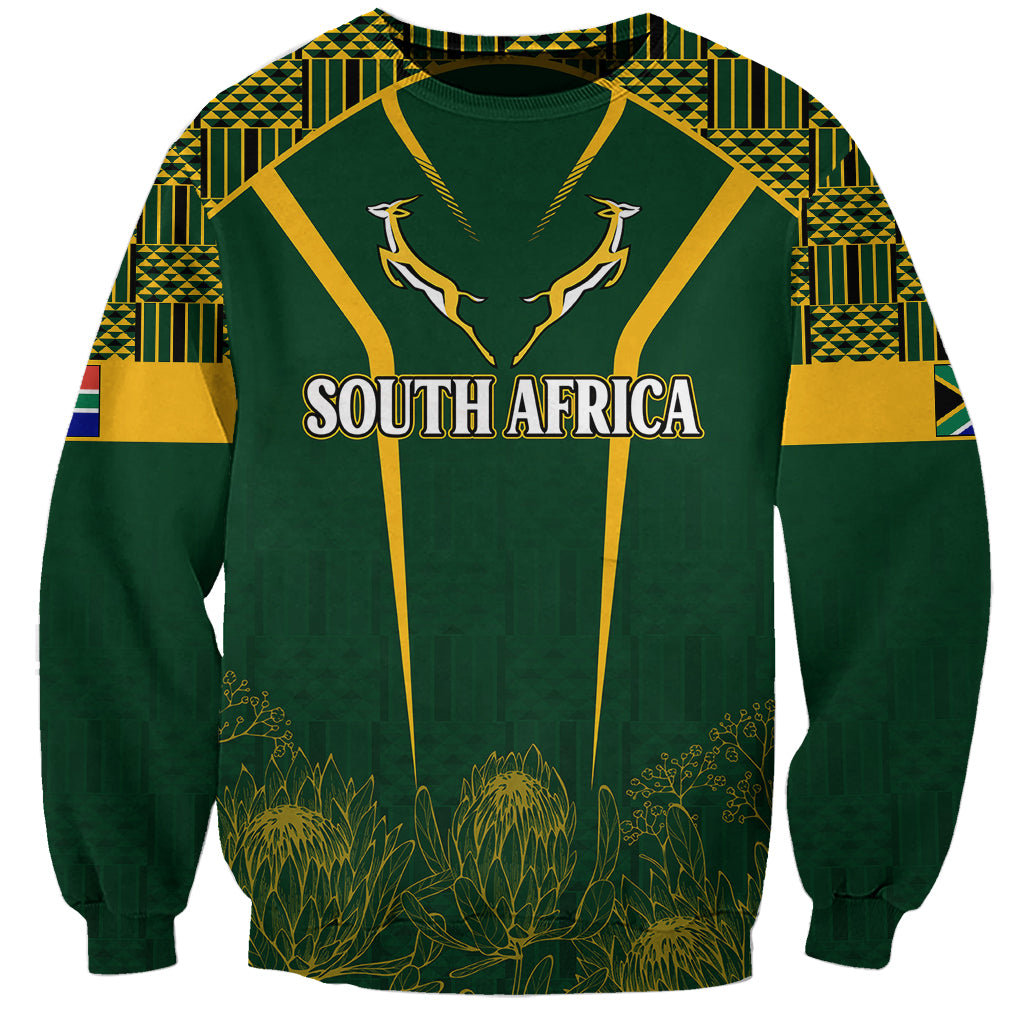 Green crewneck sweatshirt with South Africa graphic and kente-style patterns, long sleeves