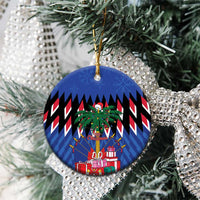 Blue round ceramic Christmas ornament with gold hanger hanging on a silver tree